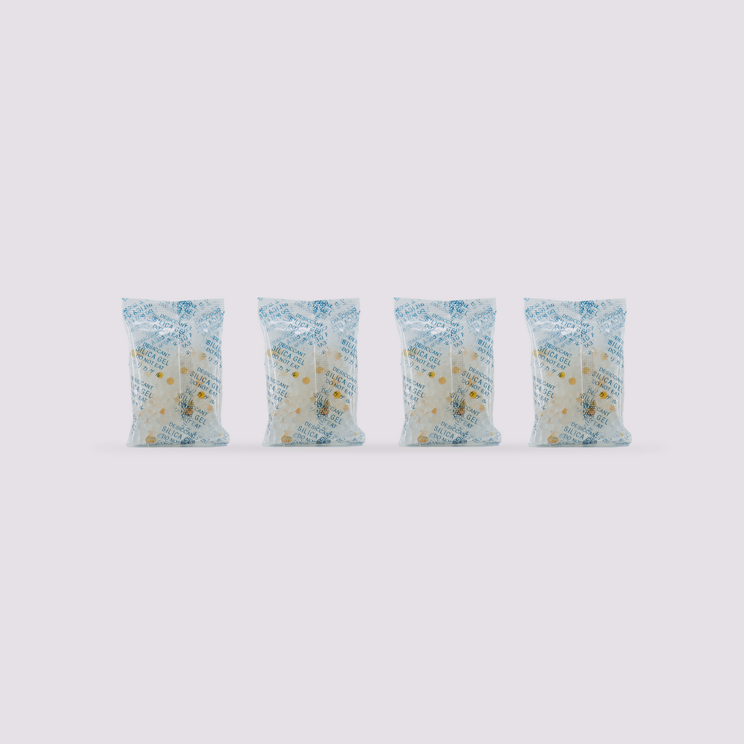 Four packets of silica gel desiccant for QIDI BOX, showing small white and yellow beads.